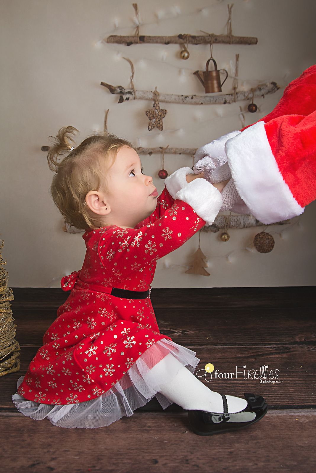 St-Louis-photographer-holiday-mini-sessions-2017-girl-in-red-dress-holding-santas-hands.jpg