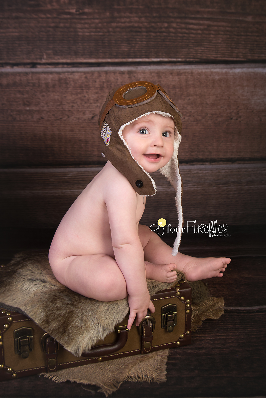 st-louis-photography-studio-6-month-milestone-session-boy-bare-bum-on-suitcase-with-avaitor-hat-and-wood-backdrop.jpg