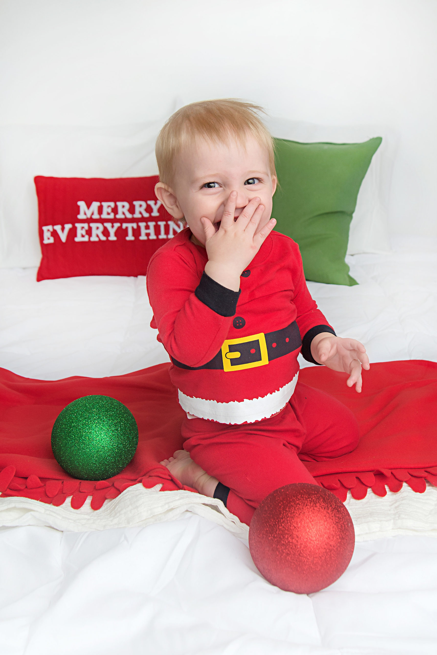 st-louis-photography-studio-christmas-picture-with-one-year-boy-in-santa-pjs.jpg