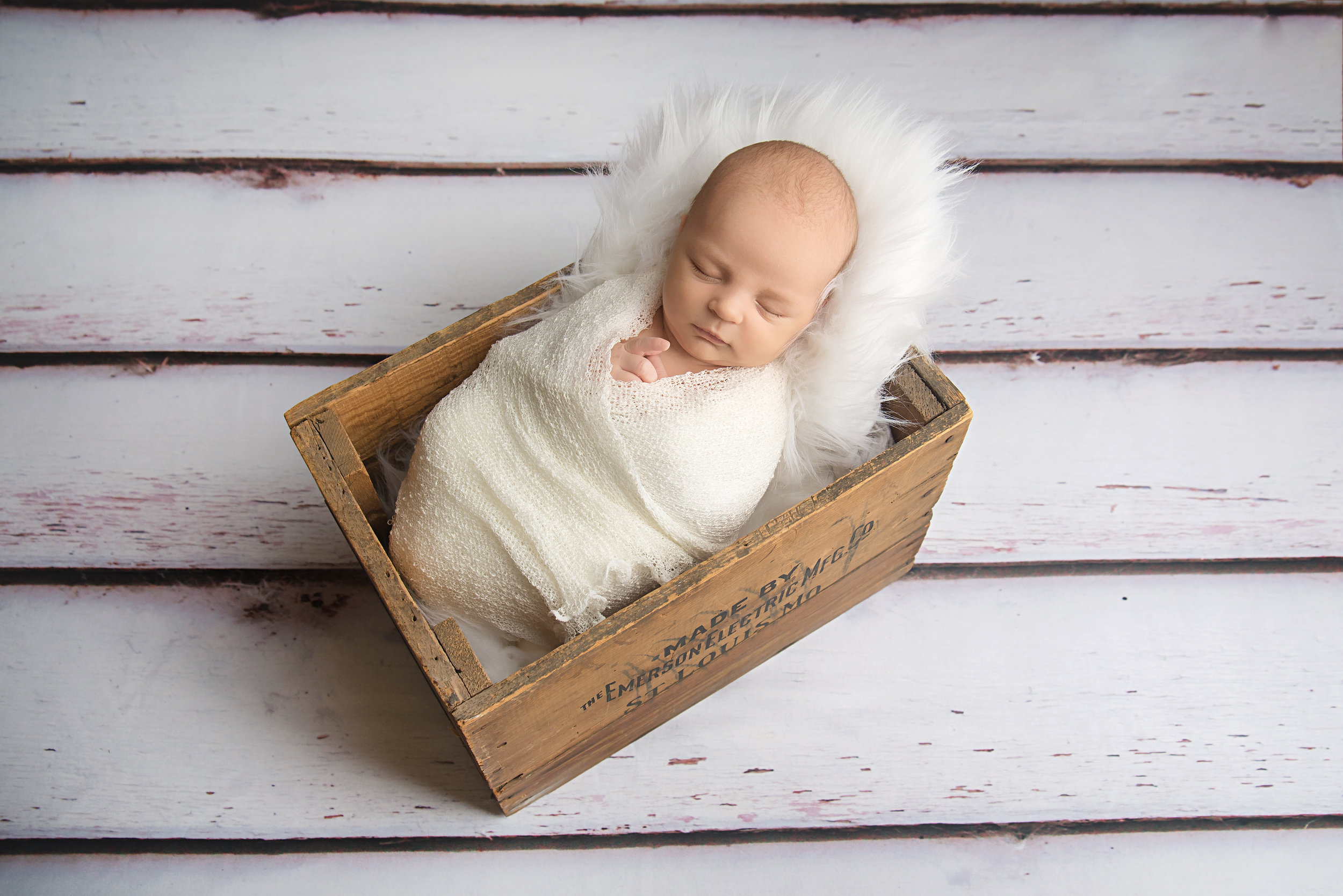 st-louis-newborn-photographer-baby-boy-wrapped-in-white-in-st-louis-emerson-electric-box.jpg