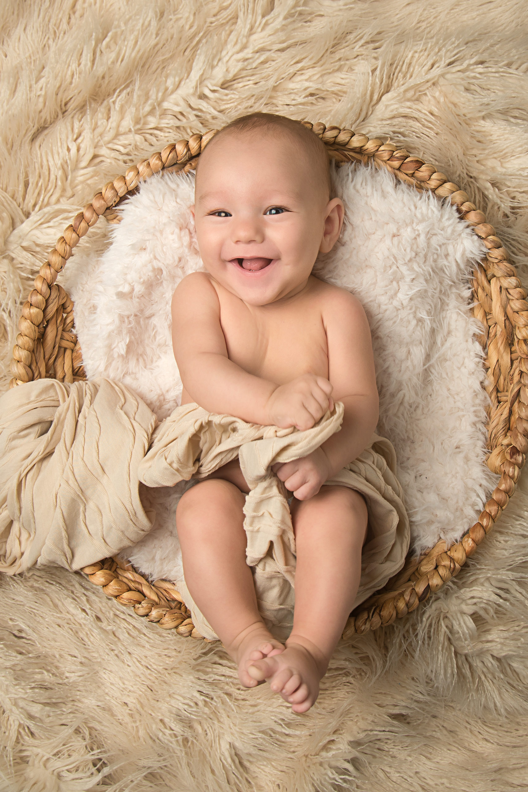 st-louis-photography-studio-milestone-session-three-month-old-boy-on-beige-with-big-smile.jpg