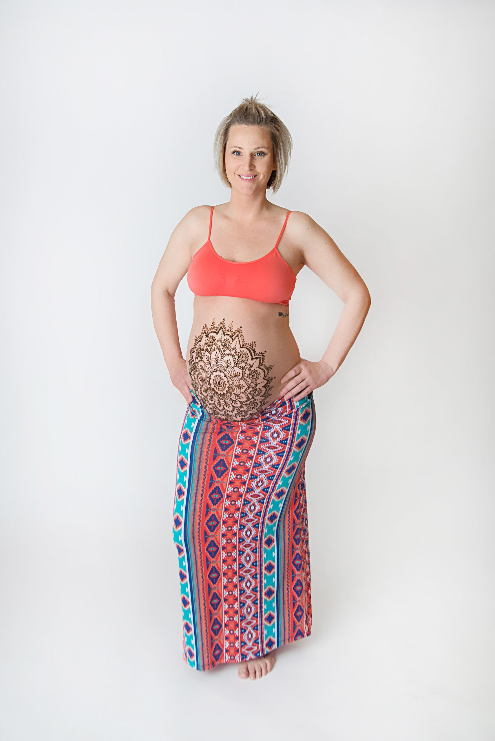 st-louis-maternity-henna-photography-pregnant-mom-in-bright-color-skirt-and-top-with-mandala-henna-bellay.jpg