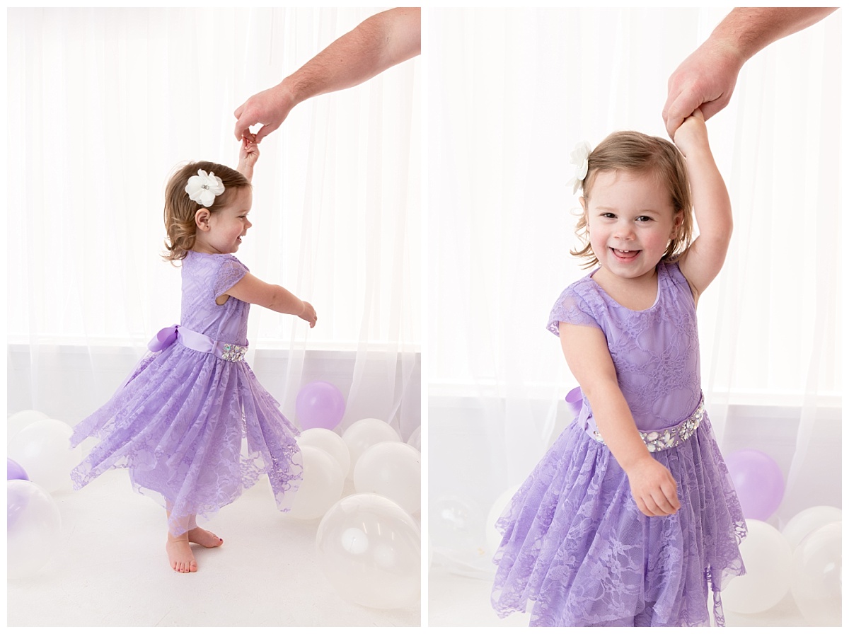 st-louis-birthday-photographer-three-year-old-girl-twirling-with-dads-hand-in-purple-dress.jpg