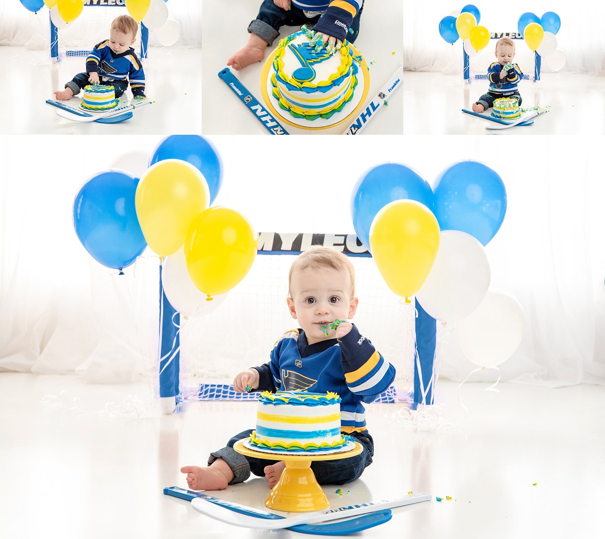 st-louis-cake-smash-photographer-st-louis-blues-theme-cake-birthday-boy-looking-down-at-blues-cake-with-net-and-balloons.jpg