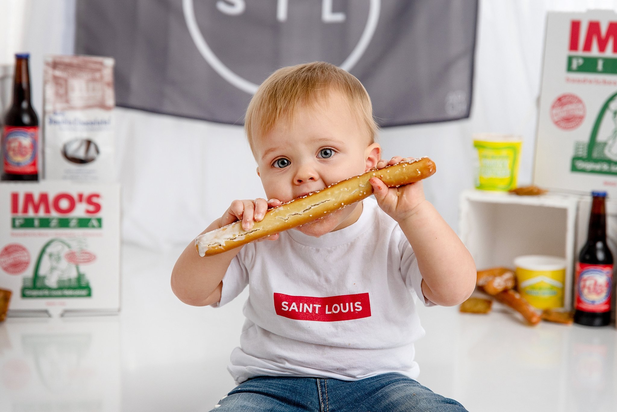 st-louis-baby-photographer-cake-smash-baby-boy-eating-giant-pretzel-stick-from-gus's-pretzels.jpg