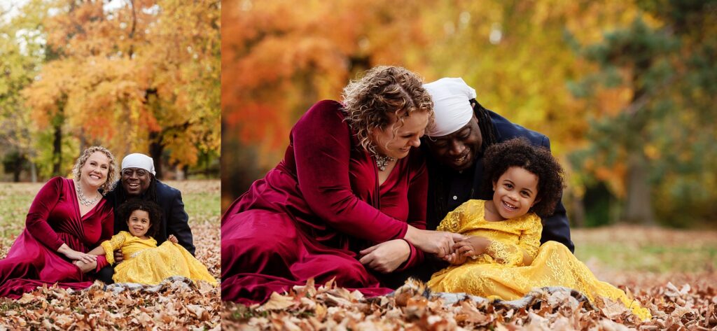 st-louis-fall-family-photographer-family-of-three-sitting-in-leaves-with-fall-colors-behind-them