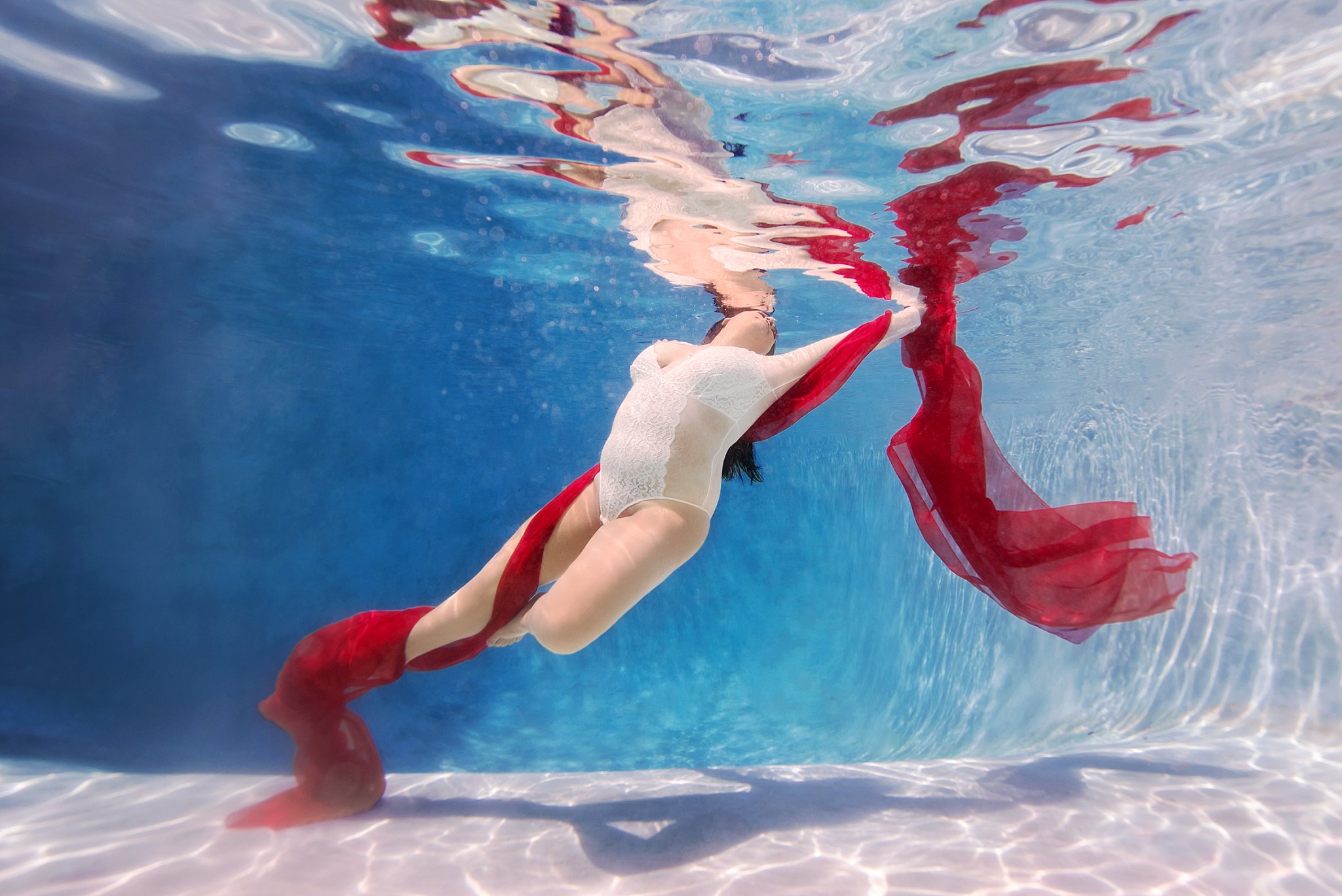 woman with red fabric underwater