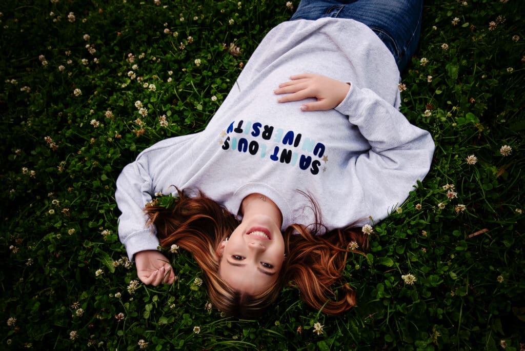 St. Louis Senior Photographer. Teen girl in St. Louis University sweatshirt to announce collage selection